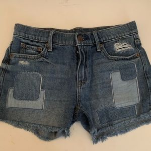 Distressed and patched jean shorts